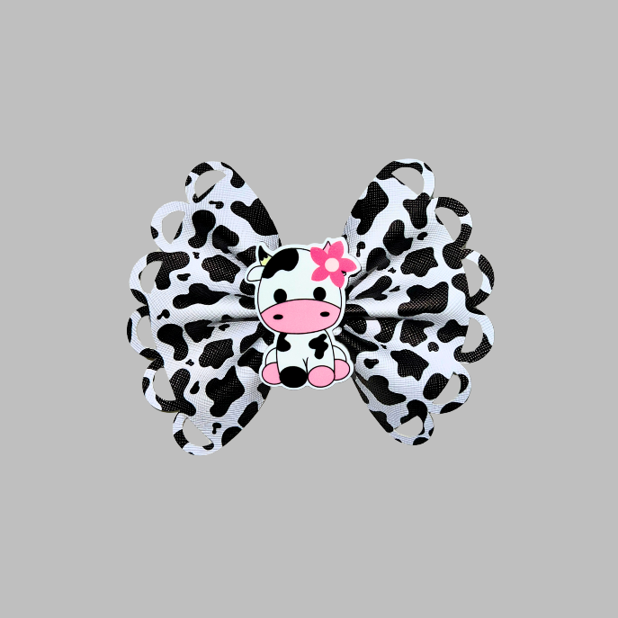 Cow Print hair bow with cow resin planar on a alligator clip.